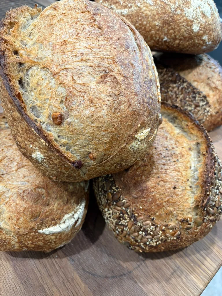 Rustic walnut sourdough loaves with toasted walnuts visible in the crust